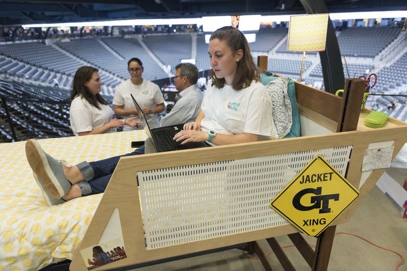  Natalie Larkins, a fourth year industrial design student at Georgia Tech, sits in her group’s demonstration bed during their presentation at the Capstone Expo. (DAVID BARNES / DAVID.BARNES@AJC.COM)