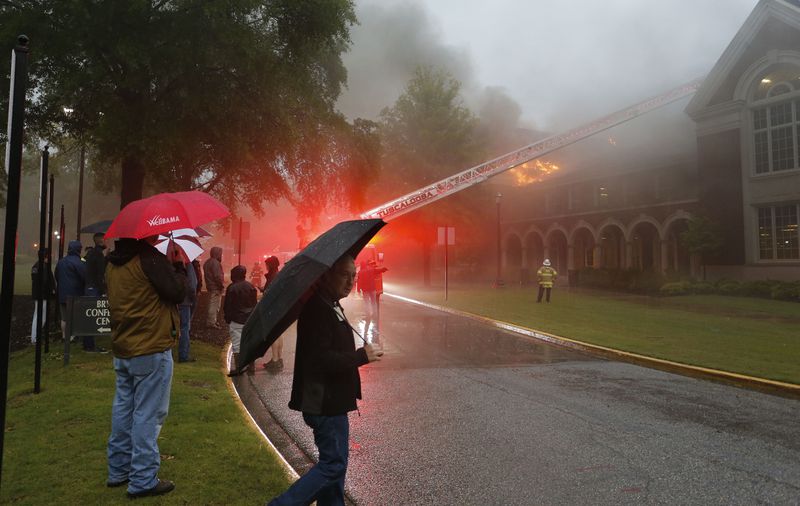 Firefighters work to control a three-alarm fire in the attic space in Moody Music Hall on the campus of the University of Alabama.