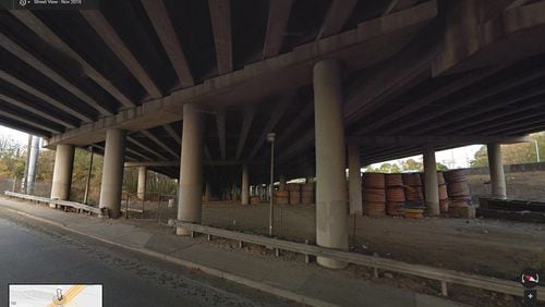 NOVEMBER 2016: This image from Google Maps Street View shows the underneath of I-85 where the interstate passes over Piedmont Road, looking to the northeast. The section that collapsed is above the stacked coils of material seen at right. (Google Maps Street View)