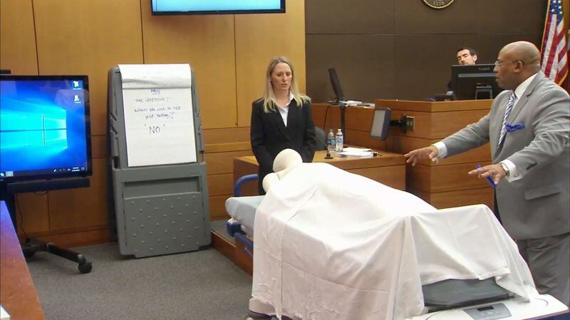 Dr. Susanne Hardy of Emory Hospital and lead prosecutor Clint Rucker use a stretcher with a manequin to demonstrate to the jury how Hardy was postitioned next to Diane McIver. The demonstration was part of Hardy's testimony during the Tex McIver murder trial on March 16, 2018 at the Fulton County Courthouse. (Channel 2 Action News)