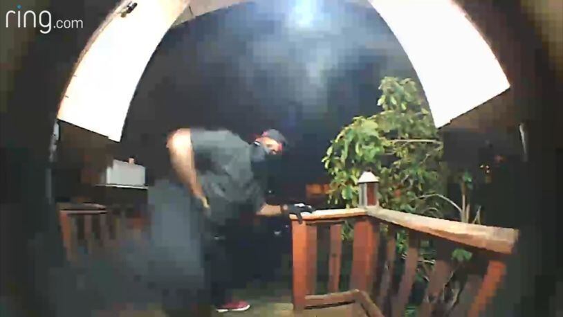 Security video image of a man trying to kick down the door of a home in Kent, Wash.