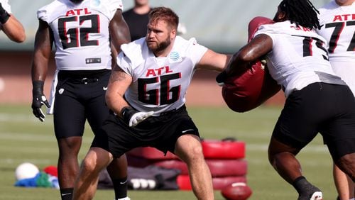 Falcons offensive guard Colby Gossett (66) runs a drill against offensive guard Justin Shaffer during the first day of training camp Wednesday in Flowery Branch. (Jason Getz / Jason.Getz@ajc.com)