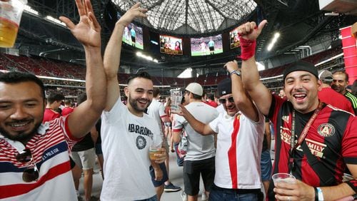 Atlanta United fans Miguel Gallardo (from left), Ricardo Goncalves, Claudio Magana, and Miguel Ortiz cheer after Croatia scores a goal while watching the World Cup final on the halo board in Mercedes-Benz Stadium before their team takes on the Seattle Sounders in a MLS soccer game on Sunday, July 15, 2018, in Atlanta. Croatia, the crowd favorite, fell 4-2 to France. Curtis Compton/ccompton@ajc.com