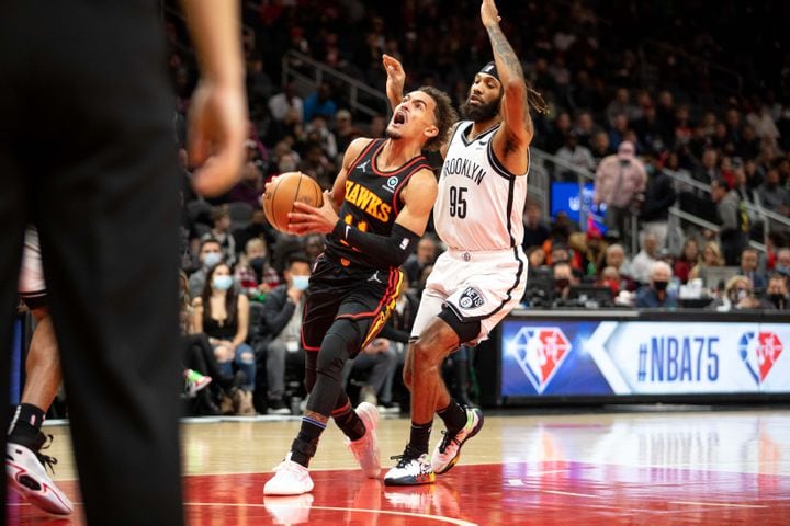 The Hawks' Trae Young (11) shoots the ball during a game between the Atlanta Hawks and the Brooklyn Nets at State Farm Arena in Atlanta, GA., on Friday, December 10, 2021. (Photo/ Jenn Finch)