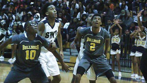 Lithonia's Bryson Rockcliffe and Justin Myles block out for a rebound in the first game with Southwest DeKalb. (Photo - Mark Brock)