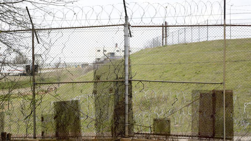 February 21, 2017, Atlanta - Patches of metal are bolted to the fence along the United States Penitentiary, Atlanta to cover holes in Atlanta, Georgia, on Tuesday, February 21, 2017. Minimum security inmates have used the holes in the fence to smuggle contraband back into the camps for years. (DAVID BARNES / SPECIAL)