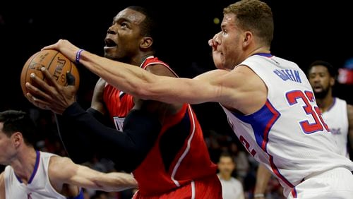 Los Angeles Clippers forward Blake Griffin, right, blocks a shot by Atlanta Hawks forward Paul Millsap during the first half of an NBA basketball game in Los Angeles, Monday, Jan. 5, 2015. (AP Photo/Chris Carlson)