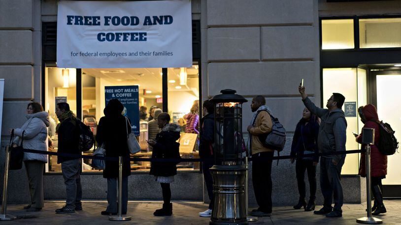 Customers wait in line outside a restaurant opened for federal workers and their families during a partial government shutdown in Washington, D.C., on Jan. 17. ANDREW HARRER / BLOOMBERG