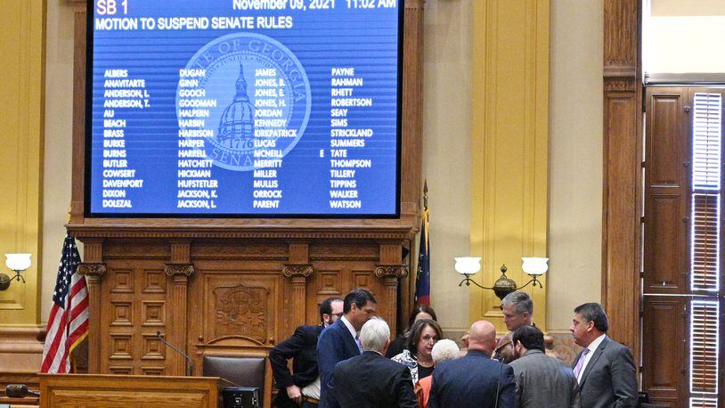 November 9, 2021 Atlanta - Lieutenant Governor Geoff Duncan and lawmakers confer as they start debating and voting on redistricting maps in the Senate Chambers during a special session at the Georgia State Capitol in Atlanta on Tuesday, November 9, 2021. The hearing was a step toward votes on new political maps for the state House, state Senate and Congress during a once-a-decade redistricting session of the General Assembly. The Senate plans to vote on new maps Tuesday, and the House Redistricting Committee could advance its proposal as well. (Hyosub Shin / Hyosub.Shin@ajc.com)