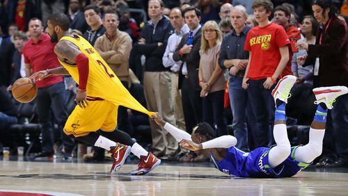 Cavaliers guard Kyrie Irving, who led the team with 43 points, is fouled while driving past Hawks guard Dennis Schroder in the final minutes of a 135-130 victory in a NBA basketball game at Philips Arena on Friday, March 3, 2017, in Atlanta. Curtis Compton/ccompton@ajc.com