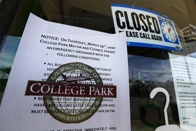 March 26, 2020 COLLEGE PARK:  A notice from the College Park Mayor & Council is posted on the front door of the closed Dance Closet business on Main Street in historic College Park on Thursday, March 26, 2020, in College Park. A patchwork of local officials, not the governor or president, this week ordered the closure of businesses across the state and forced people to shutter inside their homes over fears of COVID-19.       Curtis Compton ccompton@ajc.com