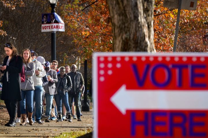 Voters at the Joan P. Garner library line up out the door and down the road as early voting is in full swing in Fulton county on Monday, Nov. 28, 2022.  (Ben Hendren for the Atlanta Journal Constitution) 
