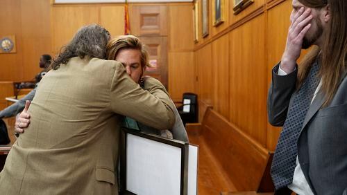 Karissa Bowley, widow of Dau Mabil, a 33-year-old Jackson, Miss., resident who went missing on March 25 and whose body was found in April floating in the Pearl River in Lawrence County, is hugged by her father James E. Bowley, following a hearing on whether a judge should dissolve or modify his injunction preventing the release of Mabil's remains until an independent autopsy could be conducted, Tuesday, April 30, 2024, in Jackson, Miss. (AP Photo/Rogelio V. Solis)