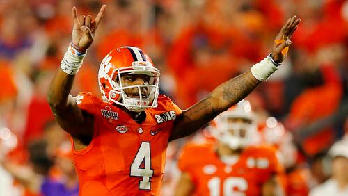 He's back: Clemson quarterback Deshaun Watson, here signalling during last season's National Championship game against Alabama, is a playoff headliner once more. (Kevin C. Cox/Getty Images)