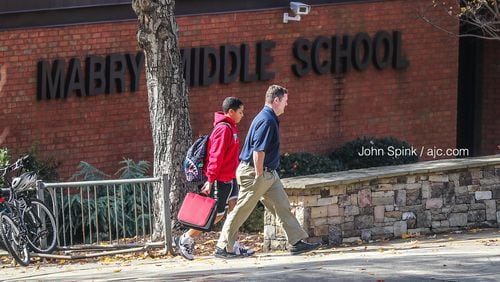 A student leaves with an adult from Mabry Middle School on Monday, Nov. 11, 2019 while it was business as usual after school district officials confirmed Monday that a Cobb County middle schooler has been diagnosed with measles (the student in the photo is not the infected student).