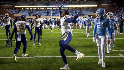 Georgia Tech's Myles Sims, center, celebrates the team's 21-17 victory over North Carolina in an NCAA college football game, Saturday, Nov. 19, 2022, at Kenan Stadium in Chapel Hill, N.C. (Robert Willett/The News & Observer via AP)