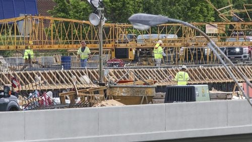 Since a fire led to the collapse of a segment of I-85 in Buckhead March 30, the Georgia Department of Transportation has scrambled to reopen the vital stretch of highway into the heart of Atlanta. Officials now say the bridge will open before May 26, ahead of the previous June date. JOHN SPINK / JSPINK@AJC.COM