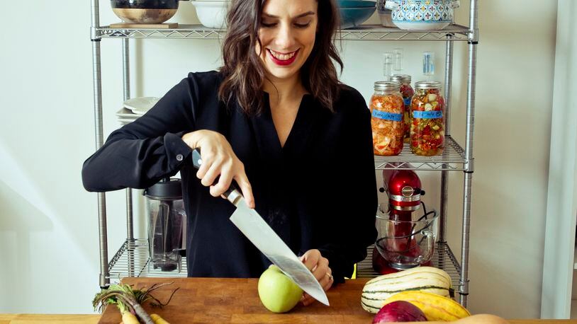 Danielle Gould, founder of Food & Tech Connect, with the four-inch-thick, 80-pound rock maple John Boos chopping block that dominates her kitchen, in New York, Oct. 21, 2015. Gould hauled the block home in 2012 after it was used for a hog-butchering demonstration at a Food & Tech Connect-organized event. Funny thing though, Gould is a vegetarian.
