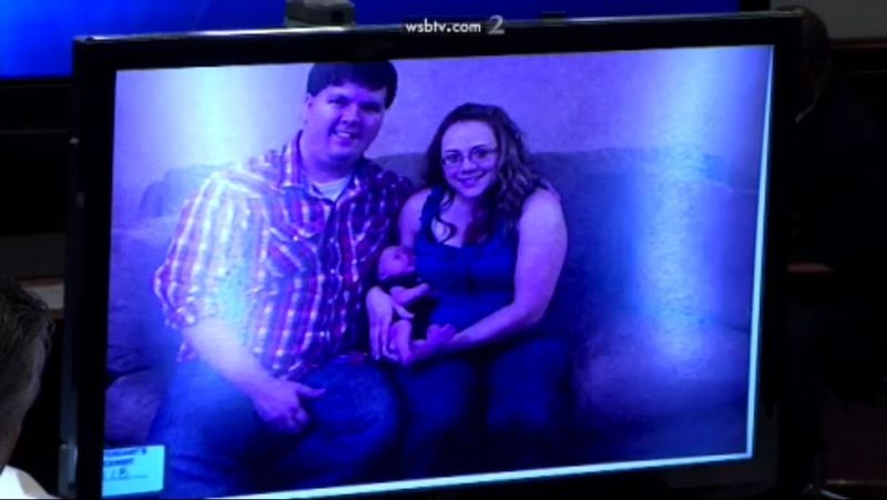 The defense shows a series of family photos of Justin Ross Harris with then-wife Leanna and baby Cooper, as Leanna describes to the jury what is in each image, during Harris' murder trial at the Glynn County Courthouse in Brunswick, Ga., on Monday, Oct. 31, 2016. (screen capture via WSB-TV)