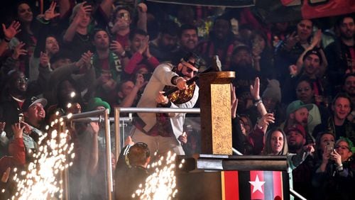 Tyree Simmons, professionally known as DJ Drama, hammers the gold spike to start the game against Portland Timbers in a MLS soccer match at Mercedes-Benz Stadium, Saturday, March 18, 2023, in Atlanta. Atlanta United won 5-1 over Portland Timbers. (Hyosub Shin / Hyosub.Shin@ajc.com)