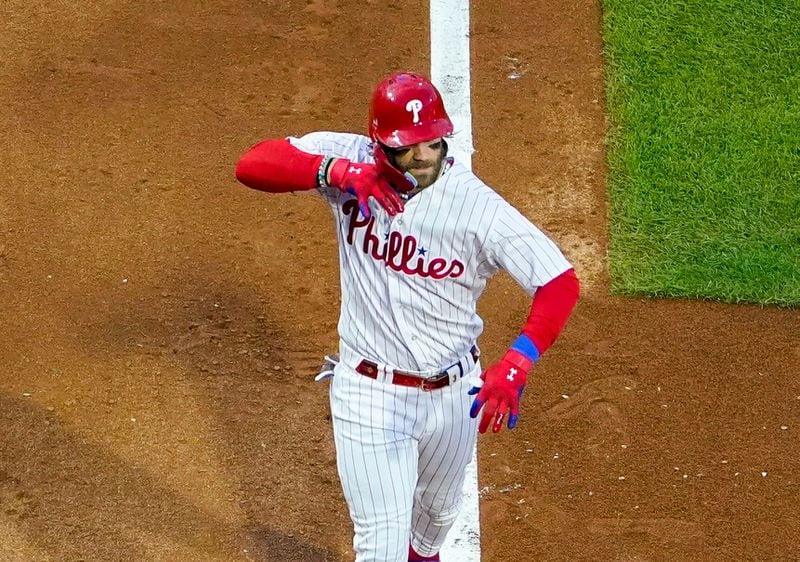 Philadelphia Phillies' Bryce Harper reacts after hitting a three-run home run during the third inning of Game 3 of a baseball NL Division Series against the Atlanta Braves Wednesday, Oct. 11, 2023, in Philadelphia. (AP Photo/Matt Slocum)