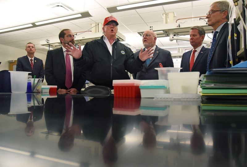 President Trump toured CDC headquarters in March, after initially scrapping the trip over concerns that a staffer at the agency had contracted the coronavirus. CDC employees and public health experts told the AJC that CDC Director Robert Redfield, picutred at right of Trump, hasn’t done enough to push back on White House meddling. HYOSUB SHIN / HYOSUB.SHIN@AJC.COM