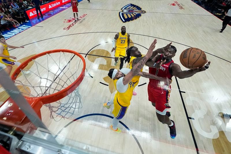 New Orleans Pelicans forward Zion Williamson (1) goes to the basket against Los Angeles Lakers forward Anthony Davis and forward Taurean Prince in the first half of an NBA basketball play-in tournament game Tuesday, April 16, 2024, in New Orleans. (AP Photo/Gerald Herbert)