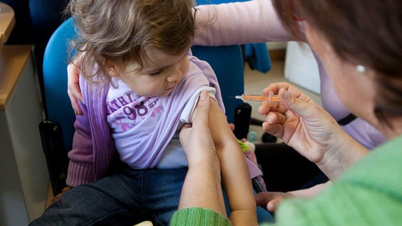 A child receives a flu shot. A new CDC study finds vaccines help prevent  flu deaths among children.