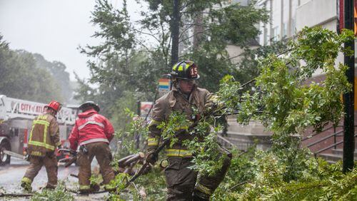 Atlanta Fire crews work to clear downed trees from roads Monday as Tropical Storm Irma moves through the metro area. (Credit: Branden Camp)