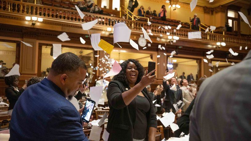 House members throw up paper at the conclusion of the legislative session in the House Chamber on Sine Die, the last day of the General Assembly at the Georgia State Capitol in Atlanta on Tuesday, April 5, 2022.   Branden Camp/ For The Atlanta Journal-Constitution