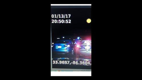 Sandy Springs police are seeking to identify the blue car in the photo after an officer was struck during a traffic stop. (Credit: Sandy Springs police)