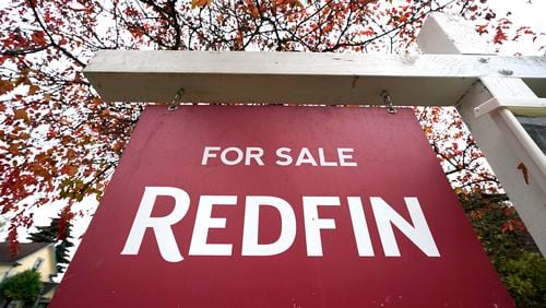 FILE - A Redfin "for sale" sign stands in front of a house on Oct. 28, 2020, in Seattle. Redfin has agreed to pay $9.25 million to settle federal lawsuits that claim U.S. homeowners were saddled with artificially inflated broker commissions when they sold their home as a result of longstanding real estate industry practices. The online brokerage and real estate services company disclosed the proposed settlement Monday, May 6, 2024 in a regulatory filing with the Securities and Exchange Commission. (AP Photo/Elaine Thompson, File)