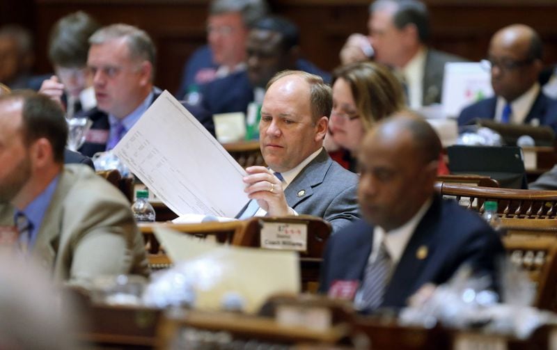 State Rep. Dan Gasaway, R-Homer, flips through the state budget in 2013. JASON GETZ / JGETZ@AJC.COM