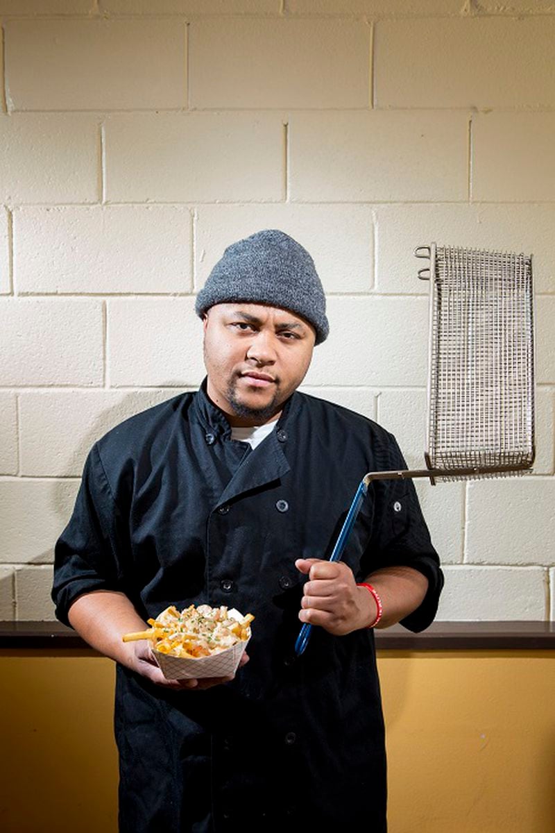 Craig Batiste, aka "Mr. Fries Man," is photographed with his first creation, lemon garlic shrimp fries ($11), inside his new restaurant on March 24, 2017 in Gardena, Calif. Starting out as a pop-up, Batiste would post on Instagram, receive orders and set-up around Gardena for patrons to pick up orders. A food-truck was short-lived, catching fire only after owning it for a couple months. (Jay L. Clendenin/Los Angeles Times/TNS)