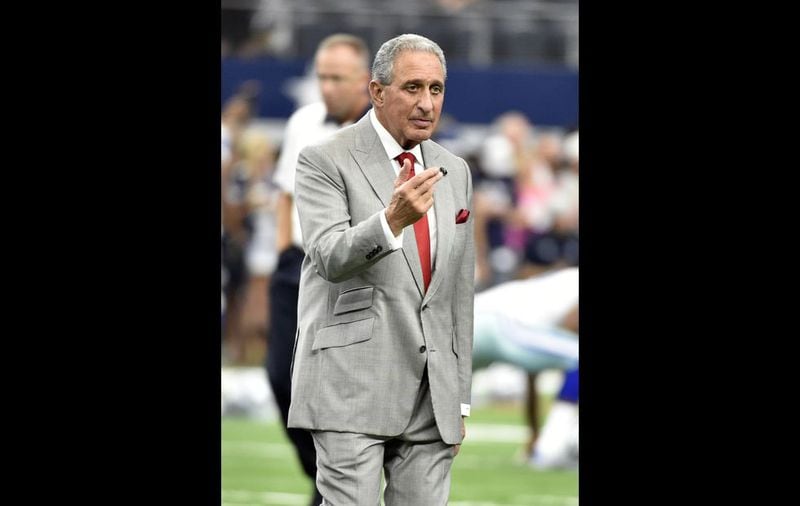 Atlanta Falcons team owner Arthur Blank walks across the field as he talks with others during team warm ups before an NFL football game against the Dallas Cowboys on Sunday, Sept. 27, 2015, in Arlington, Texas. (AP Photo/Michael Ainsworth )