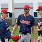 Atlanta Braves starting pitcher Chris Sale (center) and  starting pitcher Max Fried (right) smile as they talk with pitching coach Rick Kranitz during spring training workouts at CoolToday Park, Saturday, February, 17, 2024, in North Port, Florida. (Hyosub Shin / Hyosub.Shin@ajc.com)