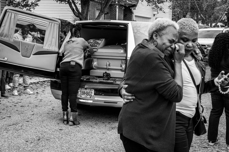 Carroll Brown (left) wipes a tear from her eye after viewing the casket of her son-in-law, Marcus Johnson, 50. Over the past two decades, several of Brown’s family members have had homegoings performed by Willie Watkins Funeral Home.