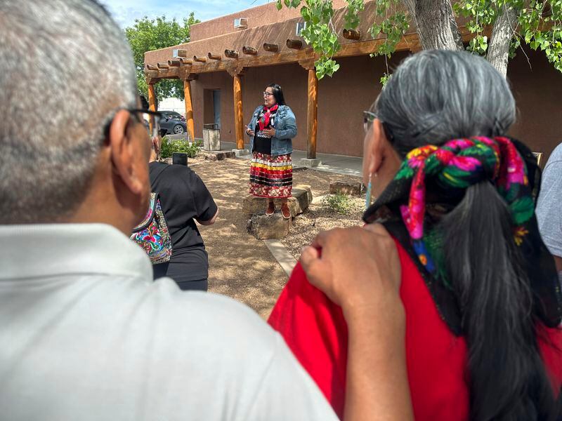 A couple holds one another as Jolene Holgate, center, addresses a crowd during Missing and Murdered Indigenous Persons Awareness Day in Albuquerque, N.M., Sunday, May 5, 2024. Dozens of people participated in a prayer walk around the Indian Pueblo Cultural Center to raise awareness about the disproportionate number of disappearances and killings that have affected Native American communities. (AP Photo/Susan Montoya Bryan)