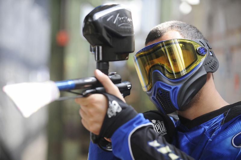 A German paintball enthusiast poses with his weapon in a paintball hall in Berlin in May 2009.