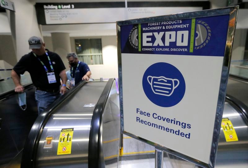 A sign at the Georgia World Congress Center recommends that conventioneers mask up last August. As a relieved nation was told in March that it was safe to unmask, many immune compromised Americans have felt left behind as everyone around them moved on. (Christine Tannous / christine.tannous@ajc.com)