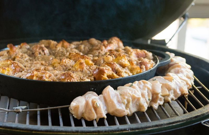 French toast casserole and chicken kebabs cook on the same grill. 