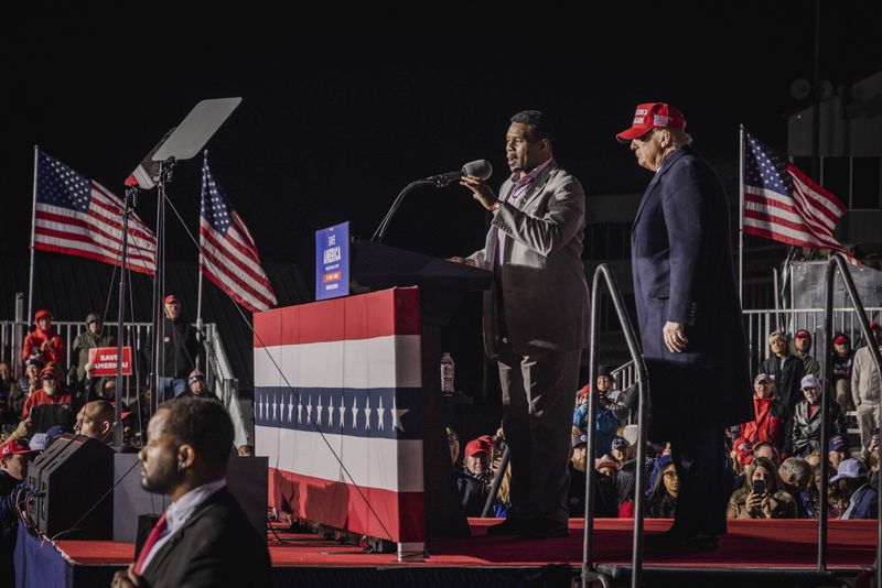 Former President Donald Trump, right, promoted former football star Herschel Walker as the Republican candidate for the U.S. Senate in 2022. But the campaign collapsed as legions of Georgians who cast ballots for other GOP statewide candidates split their ticket to back Democratic incumbent Raphael Warnock. (Audra Melton/The New York Times).