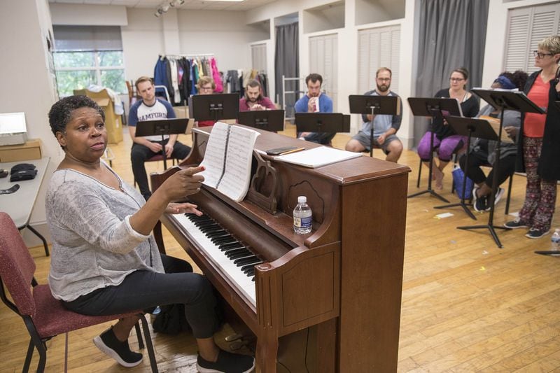 Music director S. Renee Clark leads the cast of “9 to 5” in rehearsal for their upcoming production, which opens Sept. 13. ALYSSA POINTER/ALYSSA.POINTER@AJC.COM