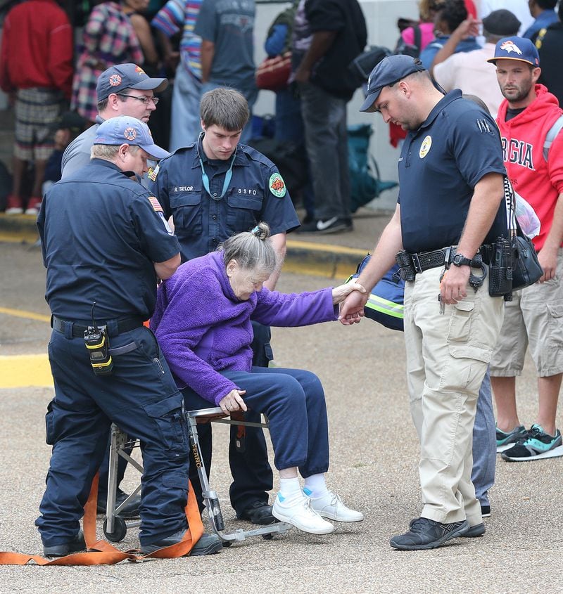 Medical personel assist a woman during the evacuation of Savannah on Saturday.  Curtis Compton/ccompton@ajc.com