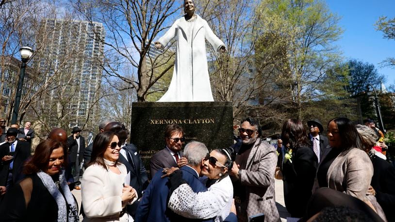 Xermona Clayton hugs statue creator Ed Dwight (center) moments after the unveiling on Wednesday, March 8, 2023. The figure was unveiled on International Women's Day and Clayton is the first black woman to have a statue in downtown Atlanta.
Miguel Martinez /miguel.martinezjimenez@ajc.com