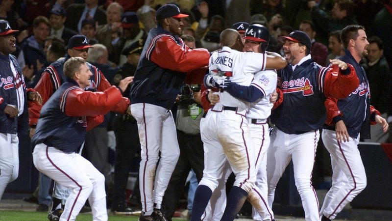 Atlanta Braves including Chipper and Andruw Jones, Otis Nixon and Mike remlinger celebrate their win in the 11th inning Tuesday night, 10/19/99, during a tense NLCS Game 6 between the NY Mets and the Atlanta Braves at Turner Field in Atlanta. (PHOTO BY FRANK NIEMEIR/STAFF)