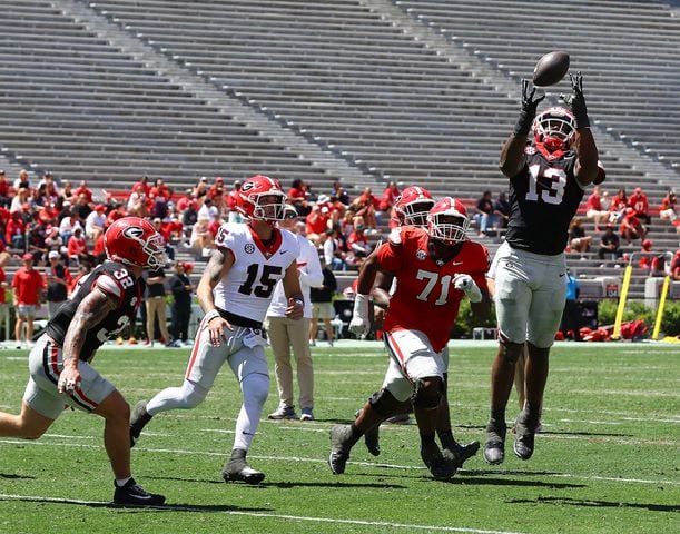 Defensive lineman Mykel Williams intercepts a pass by quarterback Carson Beck after deflecting it into the air during the G-Day game on Saturday, April 13, 2024.  Curtis Compton for the Atlanta Journal Constitution