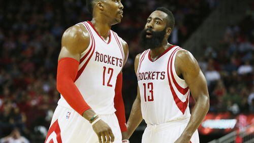 HOUSTON, TX - DECEMBER 21: Dwight Howard #12 and James Harden #13 of the Houston Rockets walk across the court during their game against the Charlotte Hornets at Toyota Center on December 21, 2015 in Houston, Texas. NOTE TO USER: User expressly acknowledges and agrees that, by downloading and or using this Photograph, user is consenting to the terms and conditions of the Getty Images License Agreement. (Photo by Scott Halleran/Getty Images)