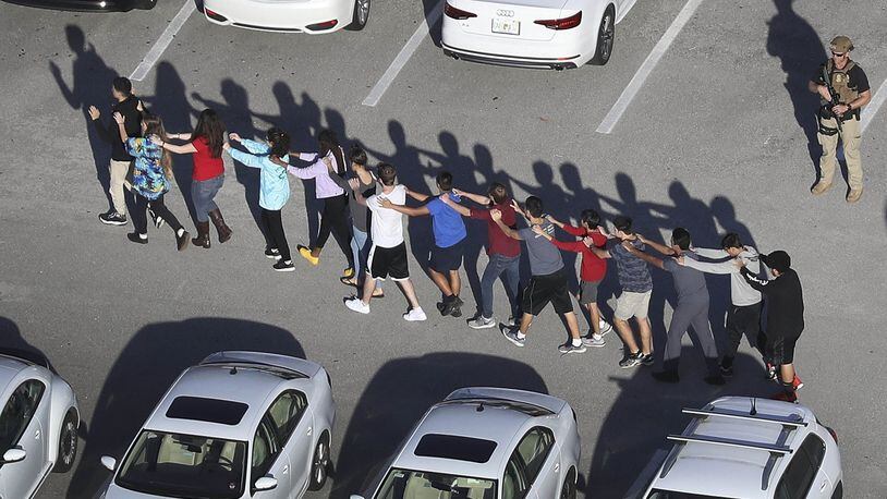 PARKLAND, FL - FEBRUARY 14: People are brought out of the Marjory Stoneman Douglas High School after a shooting at the school that reportedly killed and injured multiple people on February 14, 2018 in Parkland, Florida. Numerous law enforcement officials continue to investigate the scene. (Photo by Joe Raedle/Getty Images) *** BESTPIX ***