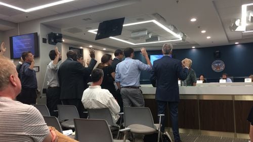 Developers, residents and city officals are sworn in at an Atlanta Tree Conservation Commission appeal hearing.